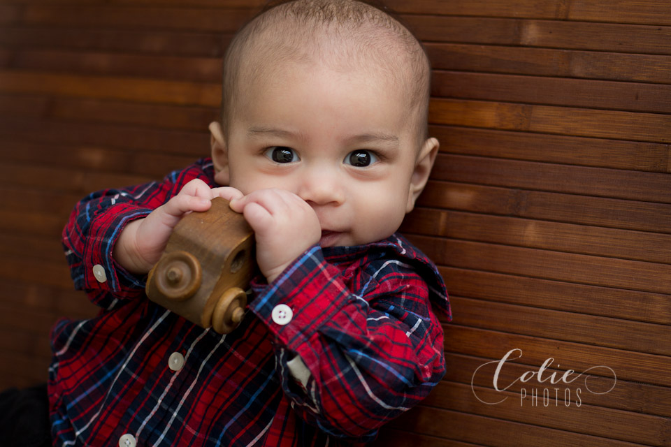Baby with wooden car
